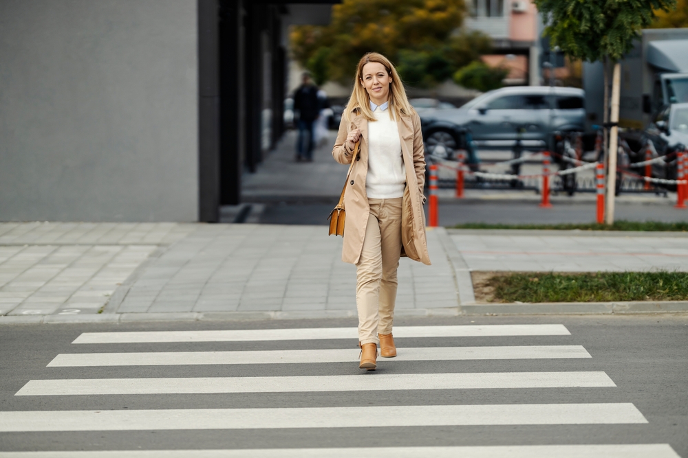 A,Trendy,Woman,Is,Walking,Across,The,Street,On,The
